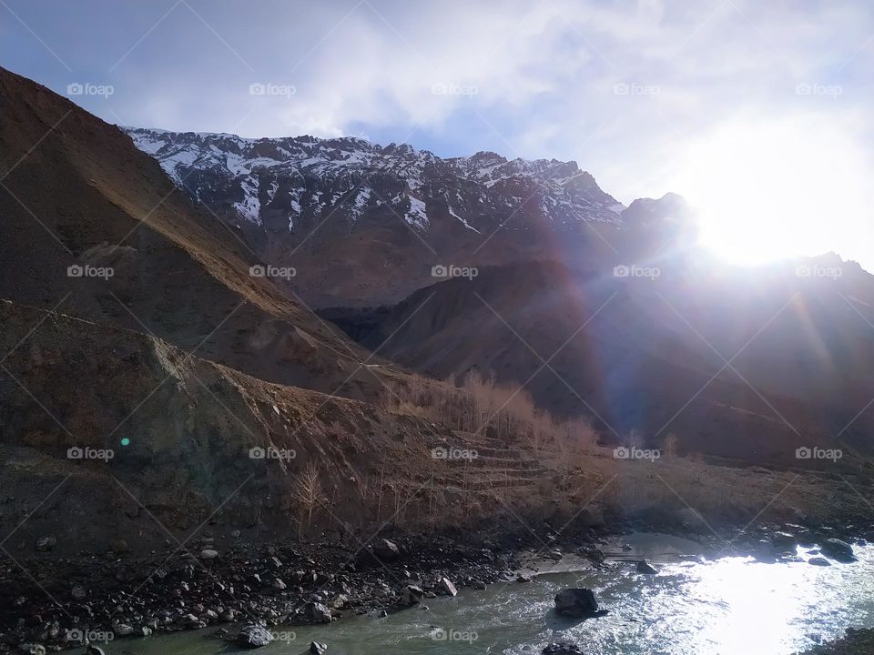 Beautiful sunrise in the mountains with flowing river