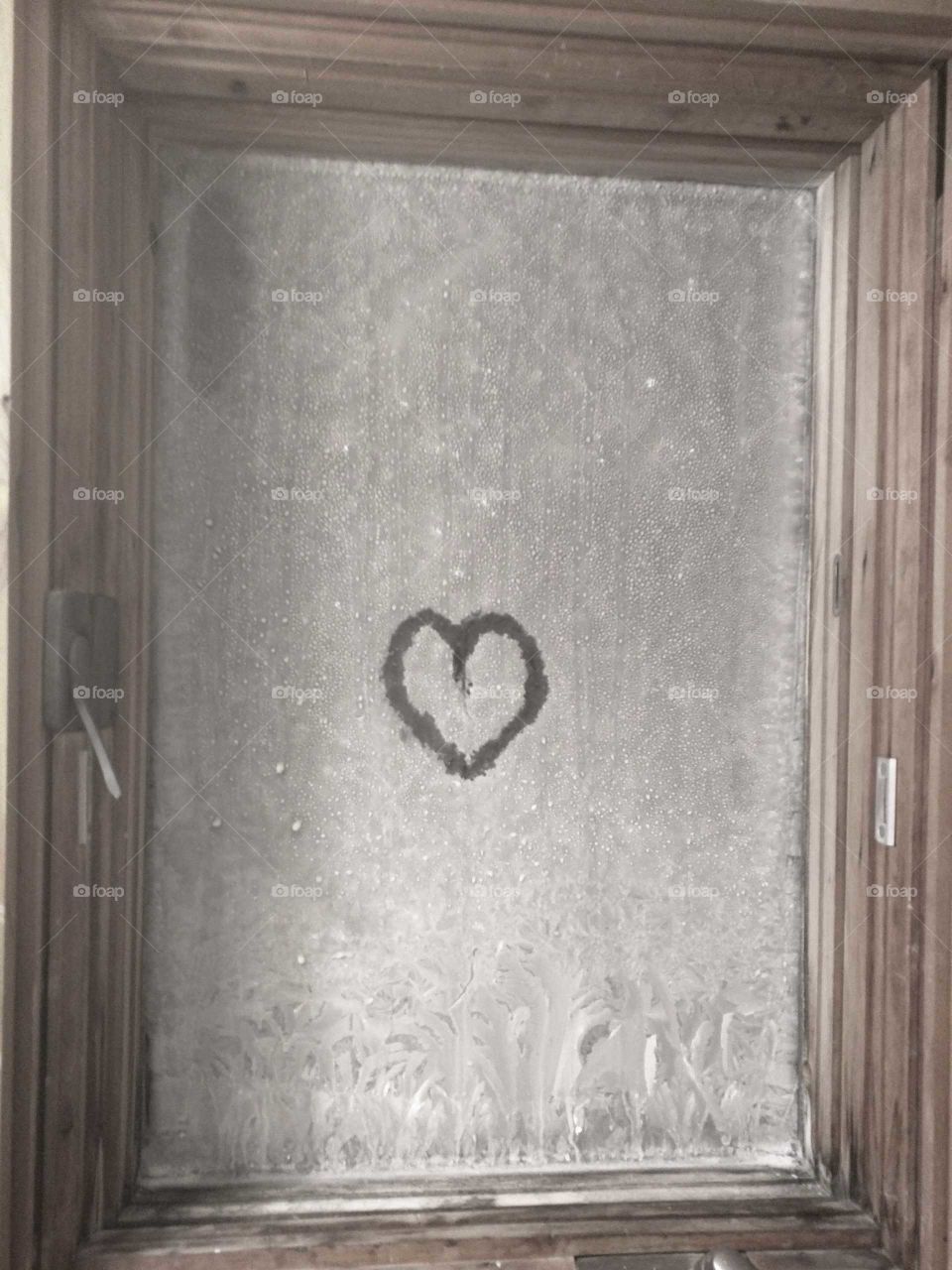 Frozen window with a heart