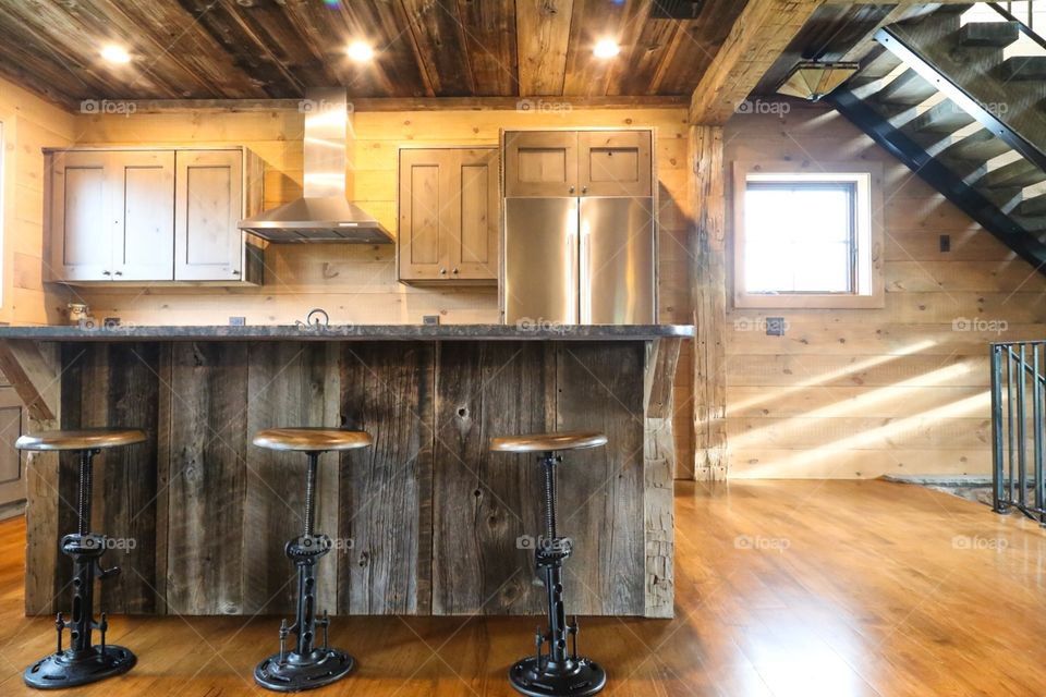 Brightly lit country house with warm wood paneling. A mix of old, rustic style with a streak of modern. 