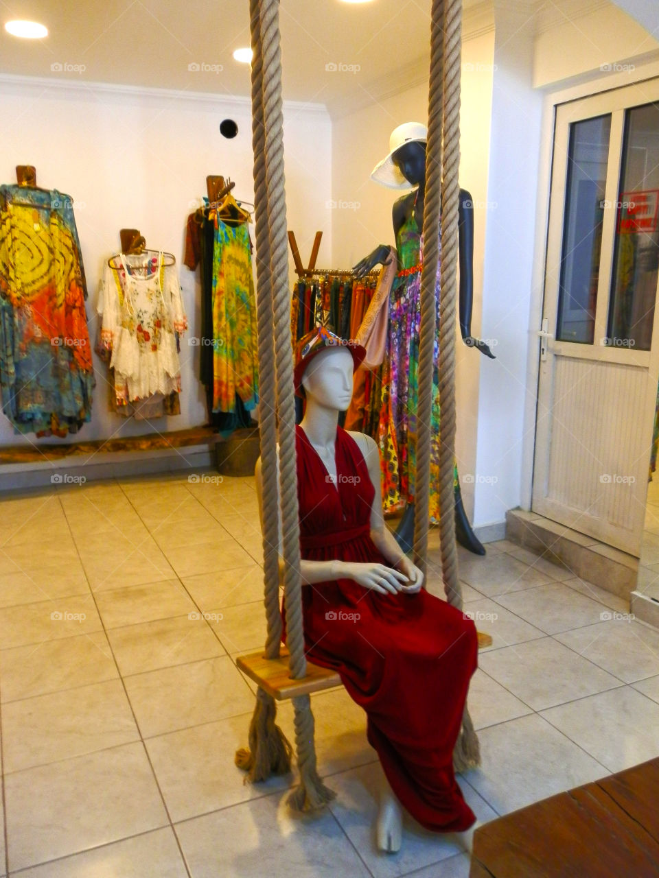 mannequin sitting on swing