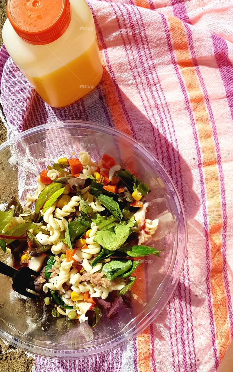 Simple pasta salad and orange juice, at the beach near my job. I think it looks nice!