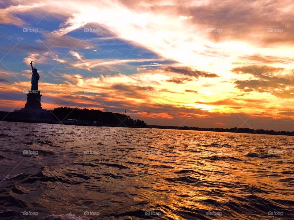 Boating down the Hudson past the Statue of Liberty at sunset