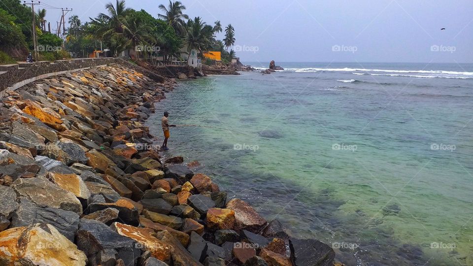 Fisherman in the sea - seaside