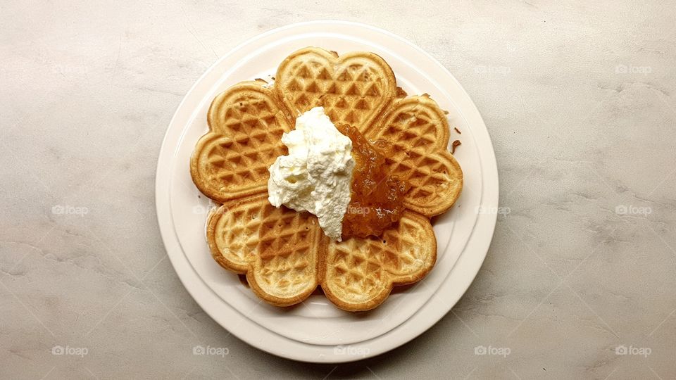 Swedish waffle with whipped cream and cloudberry jam ,  våffla med vispad grädde och hjortronsylt , svensk mat