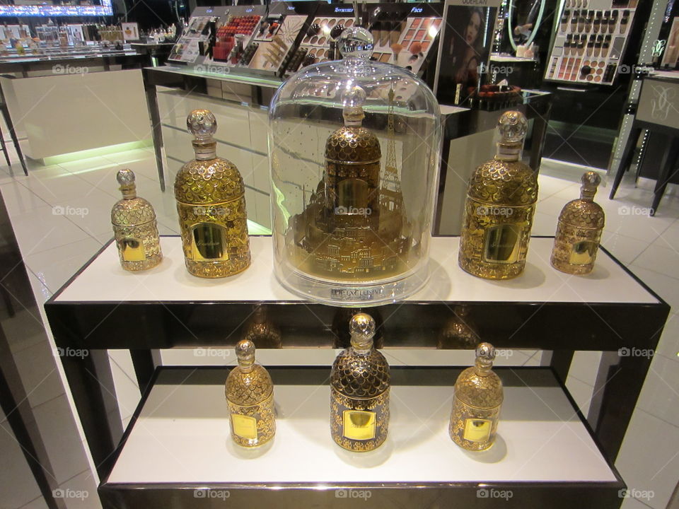 Gold, Elegant Perfume Bottles Behind Glass Display, Shop Window