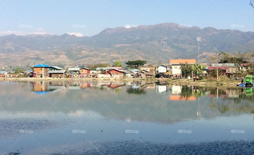 Quiet town by the water with mountains in the background