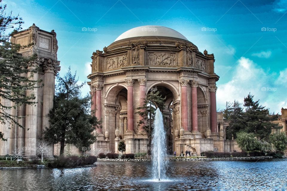 Vintage looking image of the landmark Palace of Fine Arts in San Francisco California with the fountain rising through the lagoon on a warm sunny afternoon 