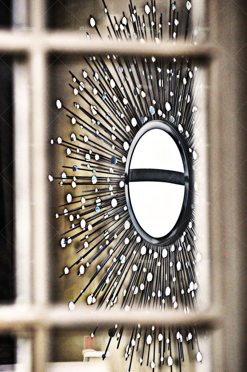 Reflecting circles of a mirror hanging on a wall