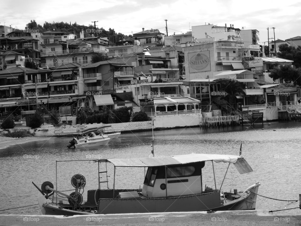 monochrome boat with city in backgroind,neos marmaras,sithonia