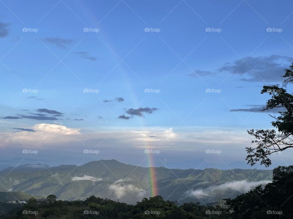 Rainbow. Blue sky. Mountains. Sunny day . Hope