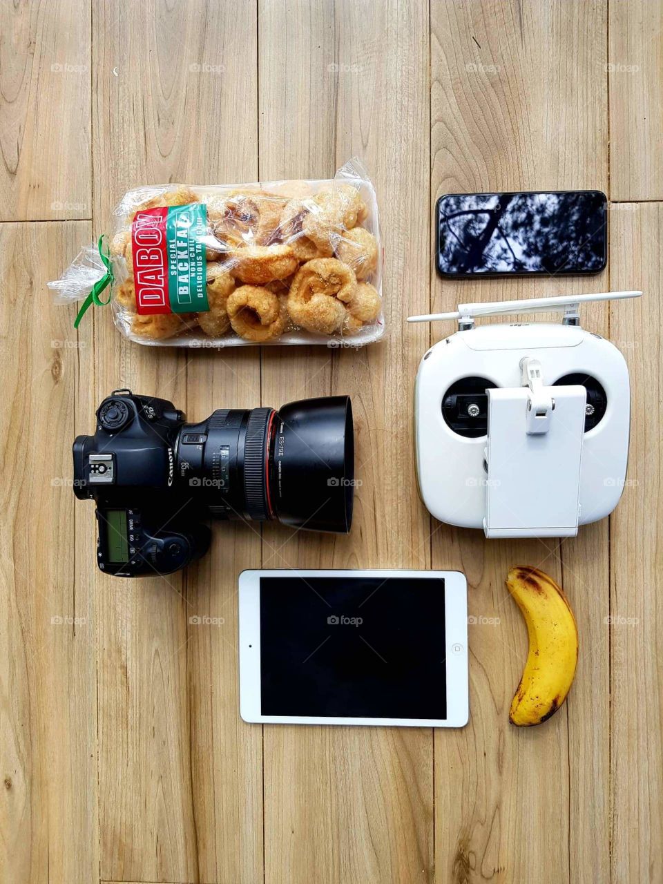 Gadgets and snacks on the table.