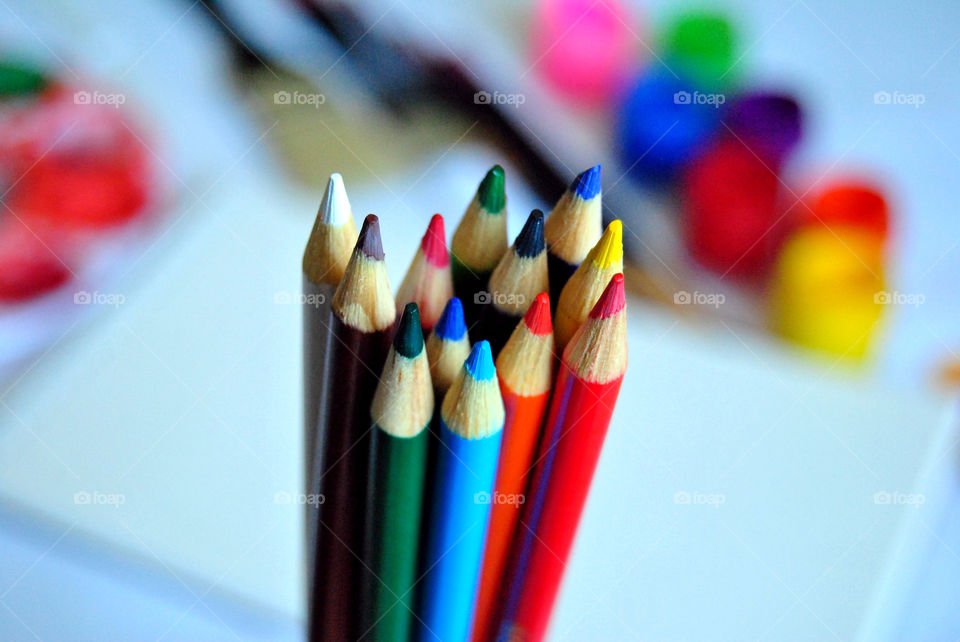 Art supplies, colored pencils, paintbrushes, paint, sketch book, watercolor pad, palette