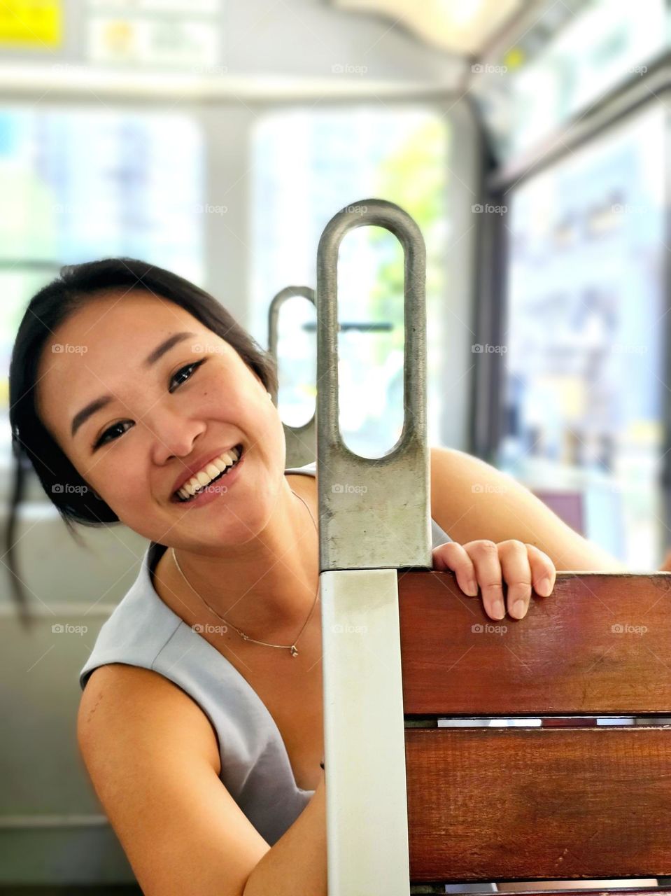 Lady with a big smile enjoying her tram ride on a sunny day