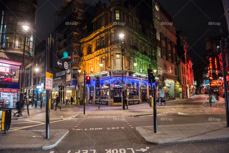 Streets of London at night near Picadilly Circus. At your left Jamie's diner named after the famous TV chef Jamie Oliver. In the middle a local pub and at your right a strippclub.