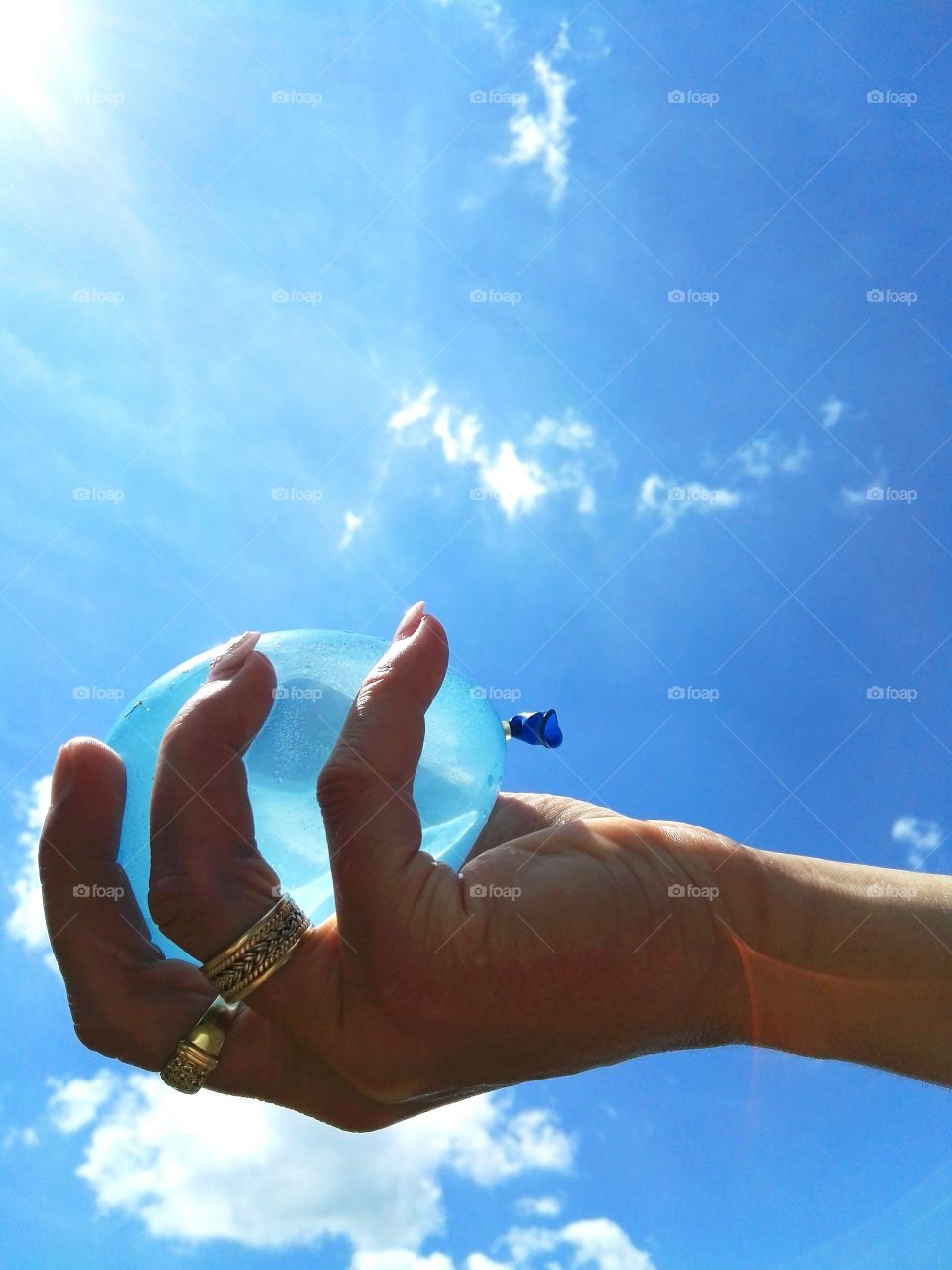 holding blue water balloon