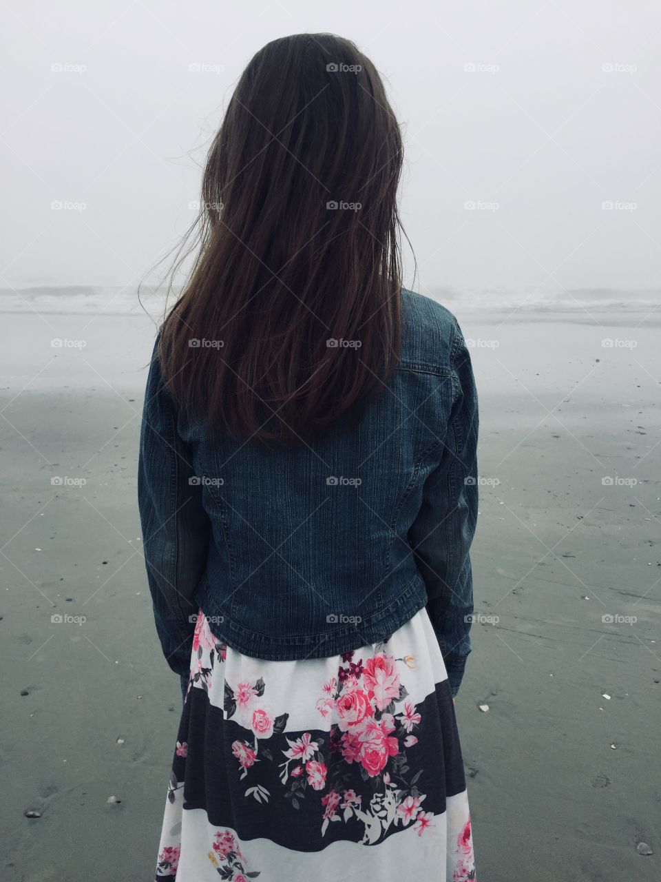 Girl looking out into the ocean 