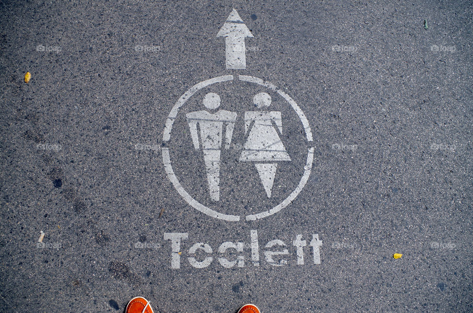 High angle view of toilet marking on asphalt.