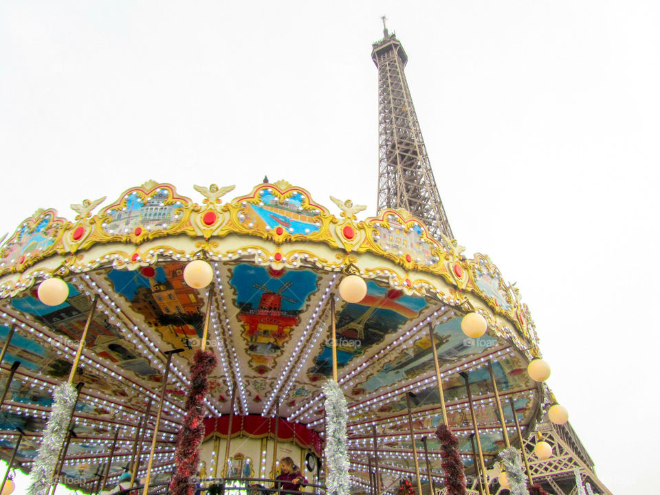 The colorful eiffel tower carousel near the base of the eiffel tower
