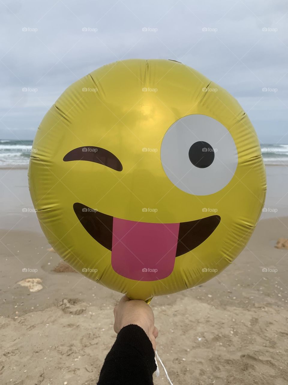 Helium balloon emoji shape at the beach