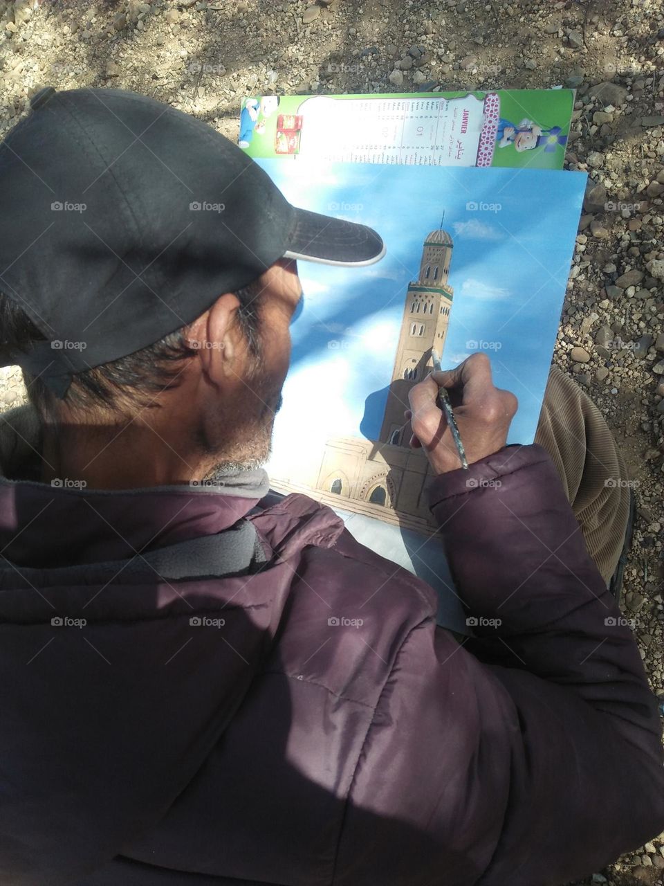 Painter paints a painting of the Marrakech silo