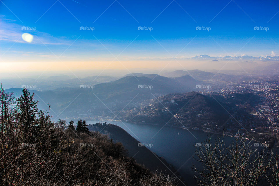 Lake by mountains against sky