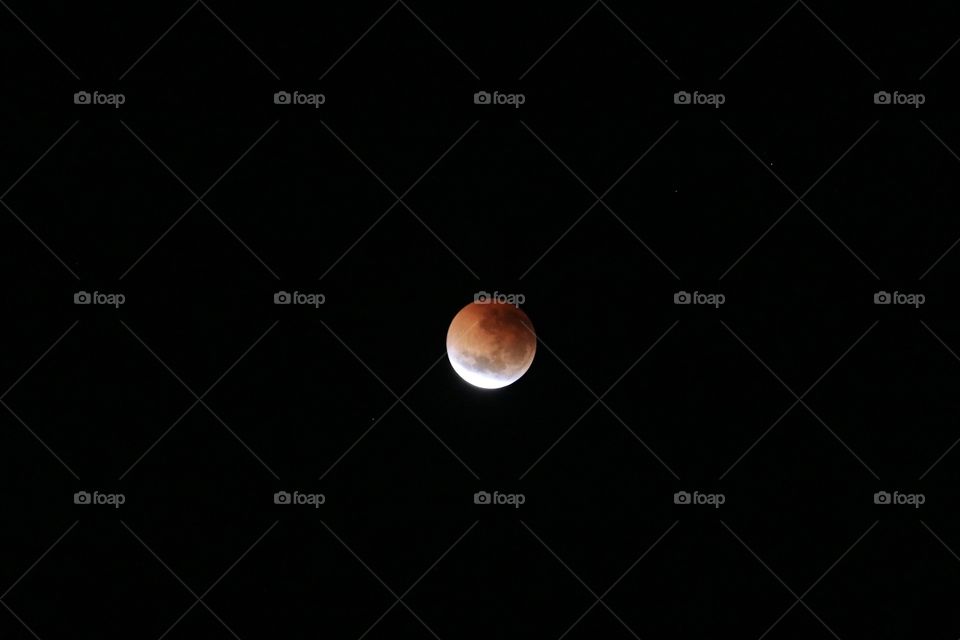 Lunar eclipse in night sky, blood crescent moon July 2018 from South Australia 