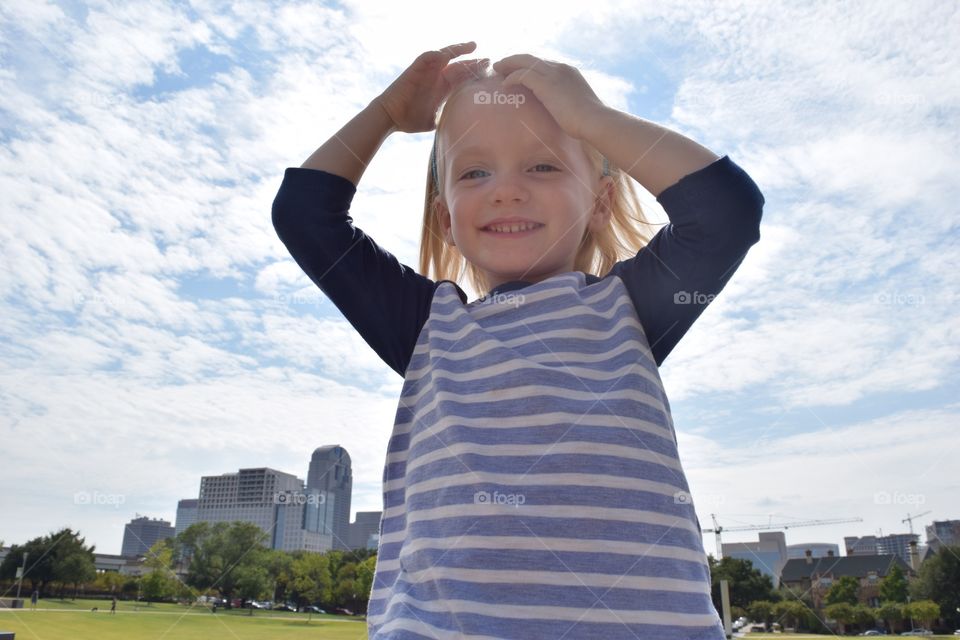 Toddler at city park. Giant toddler takes over Dallas