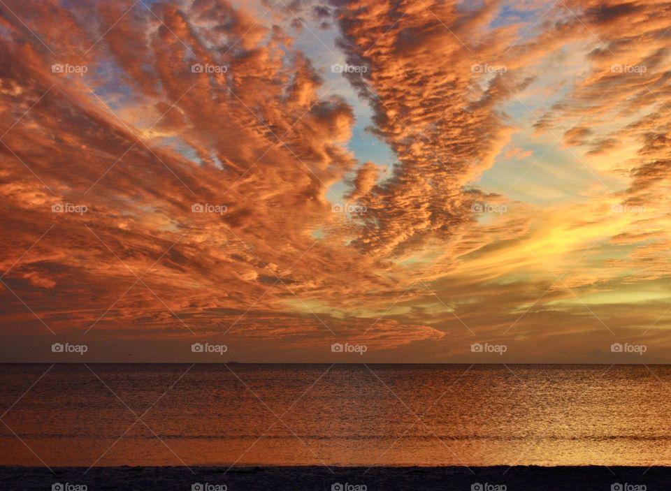 Beautiful orange clouds reflecting into the ocean