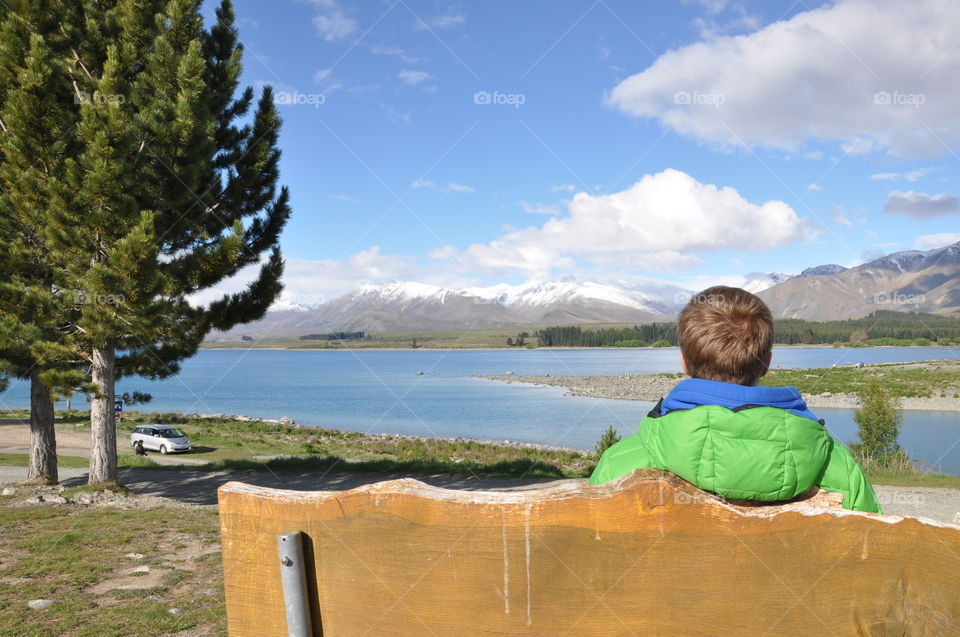 man enjoying view over snowy mountains