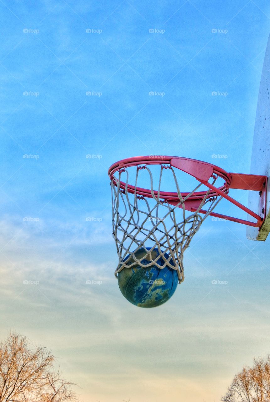 Basketball as it falls through the hoop.