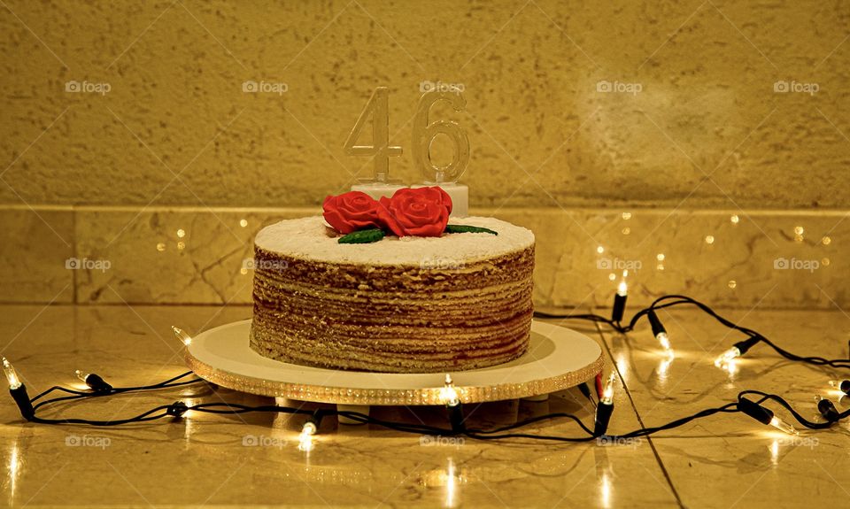 Birthday cake on golden background