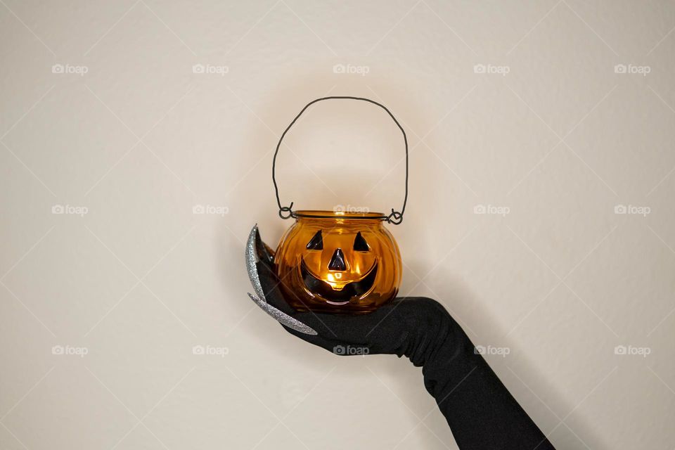 Candlestick in witch’s hand with long nails