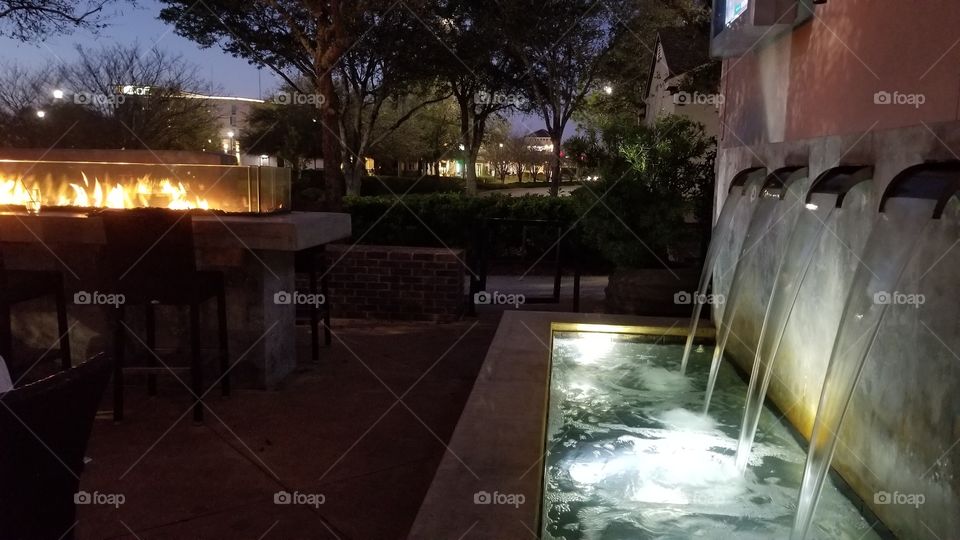 Patio waterfall and fire displays at night