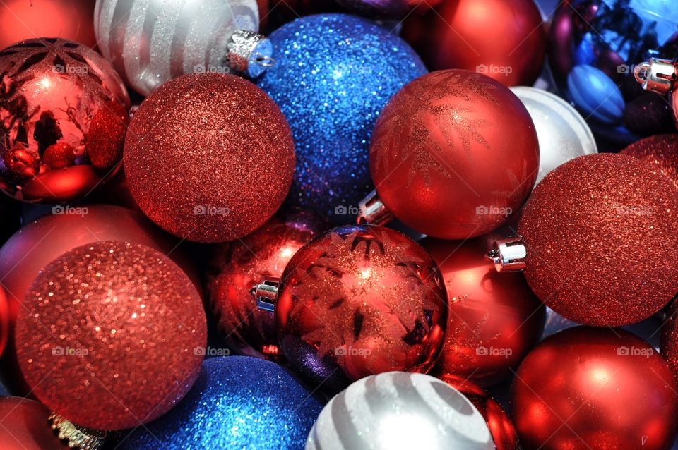 A collection of red white and blue Christmas tree ornaments.