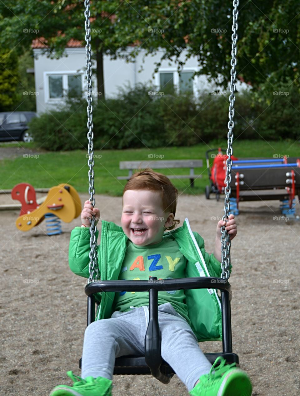 Boy hanging on a swing