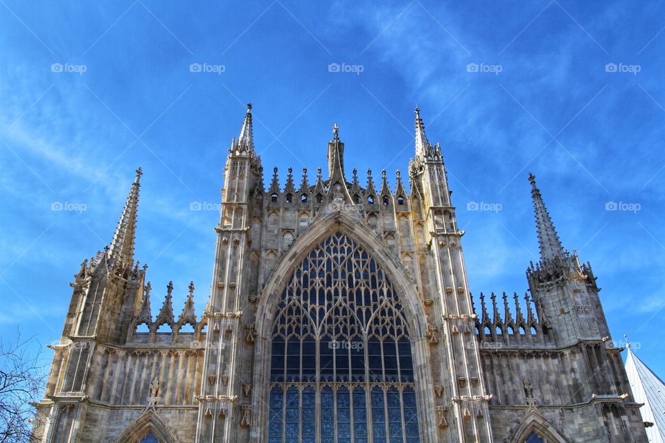 The west window of York Minster on a beautiful day. A large church.