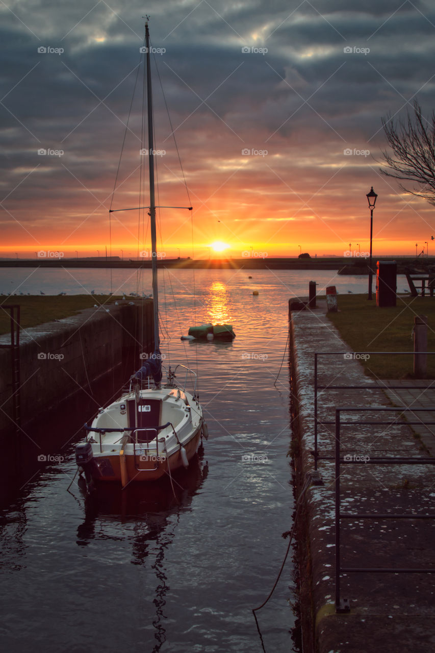 Sailboat at beautiful sunrise, Claddagh, Galway, Ireland