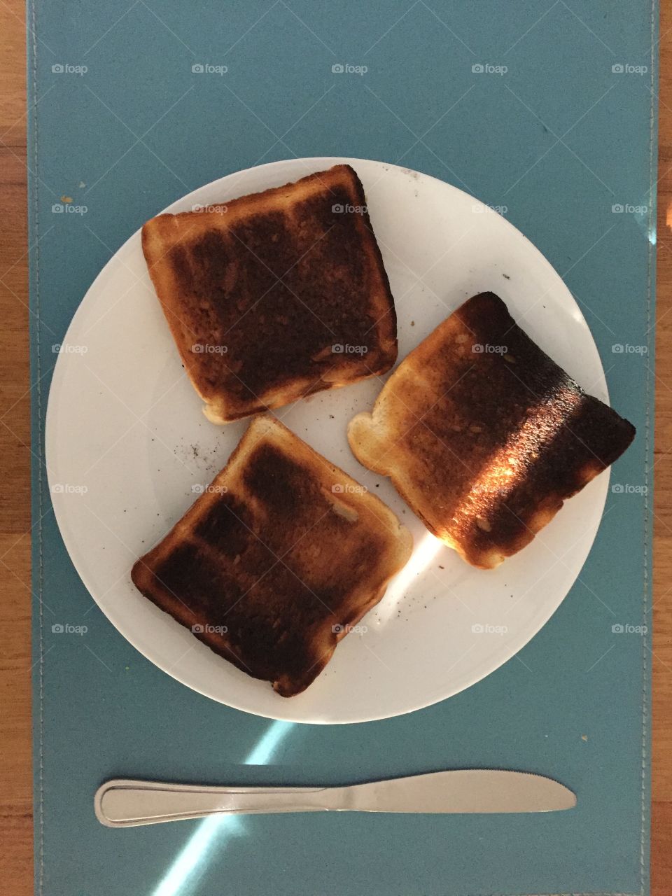 Burnt toast on plate to eat