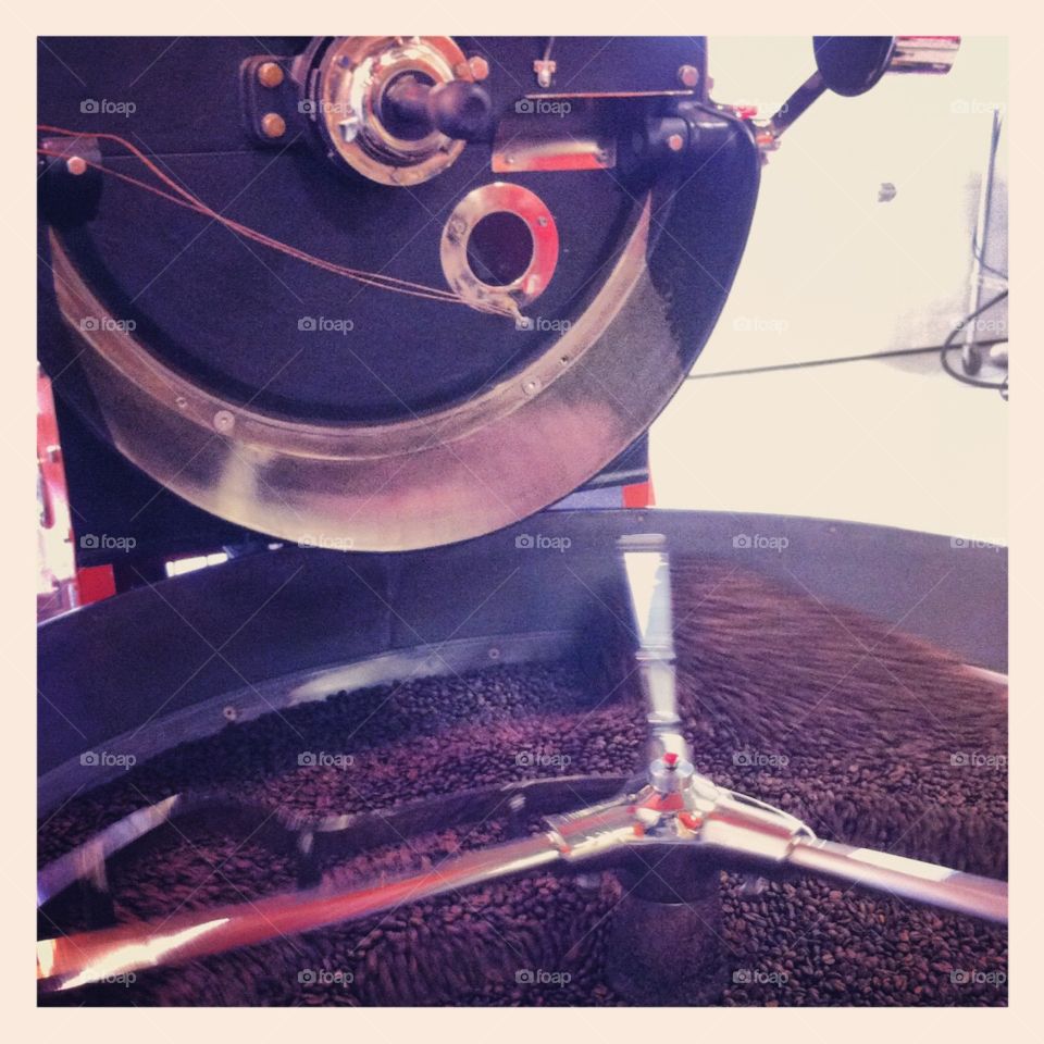 Coffee beans being roasted in a machine