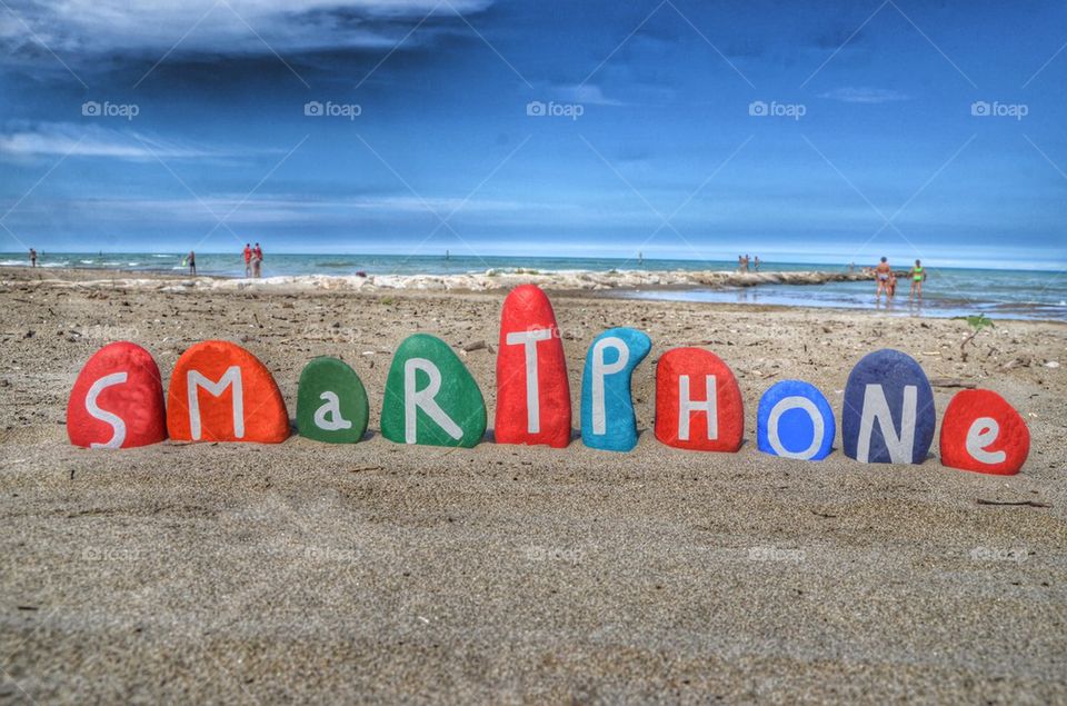 Smartphone concept on colored stone letters