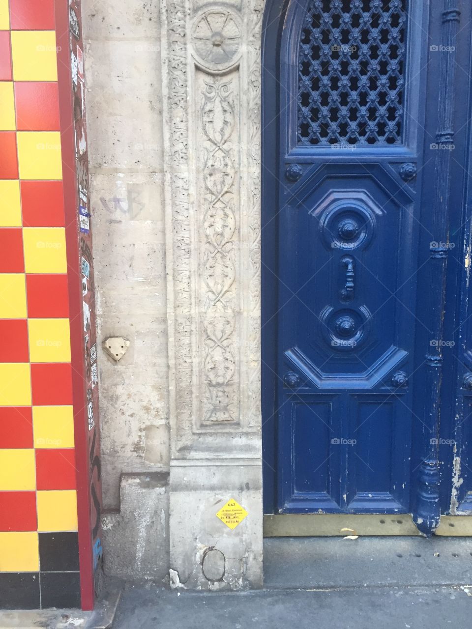 Blue Parisian Doorway next to a market entryway 