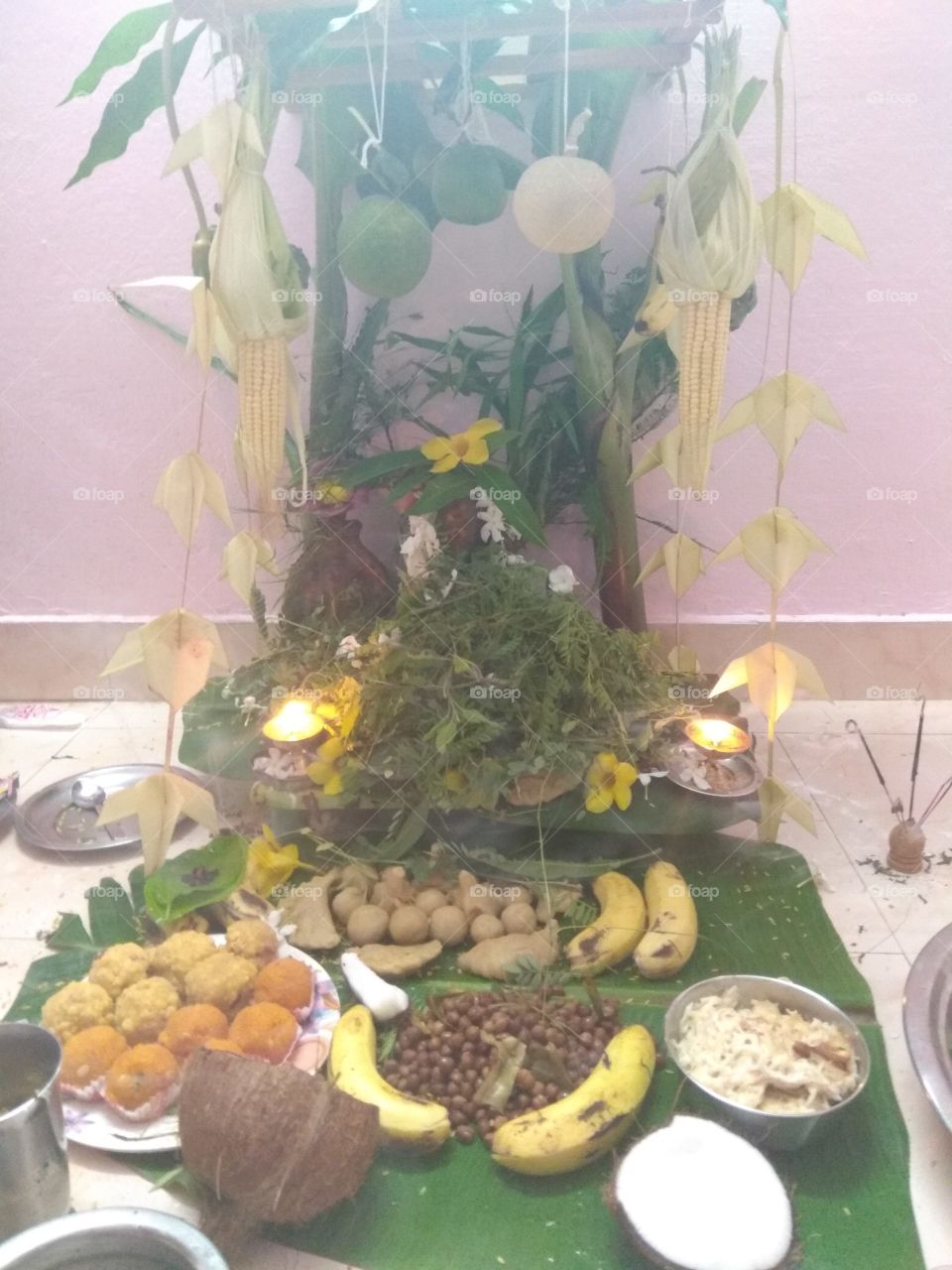 Lord Ganesh typical praying style on an auspicious day in India. they will decorate the small to very huge statues of Ganesh n pray by throwing the different types of leaves n fruits on it while reading his life storey. very interesting storey.