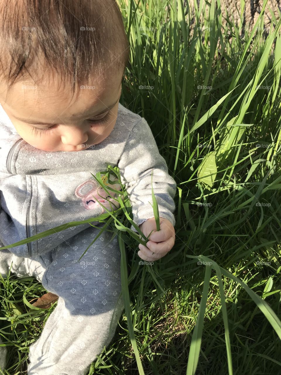 Baby touching grass