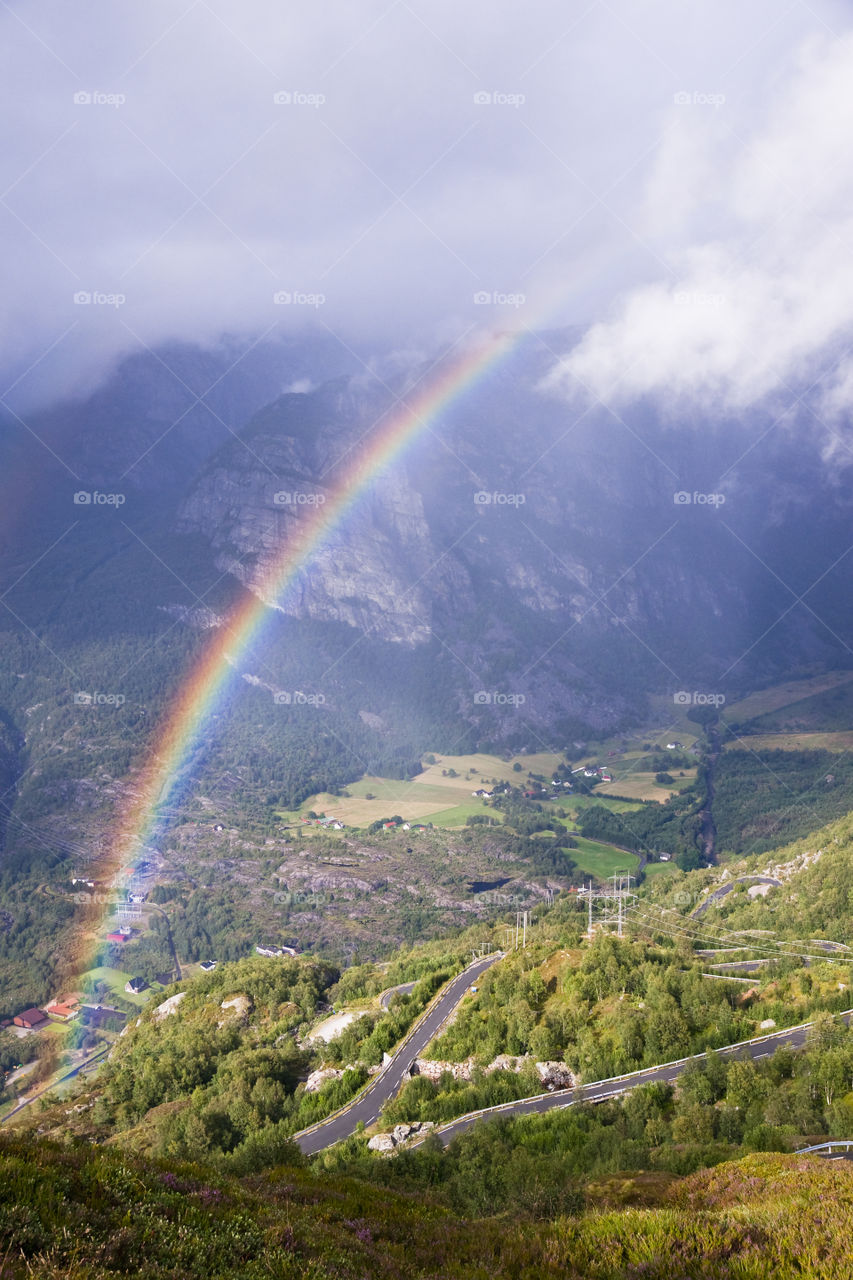 Rainbow over a valley Lysebotn. Norway