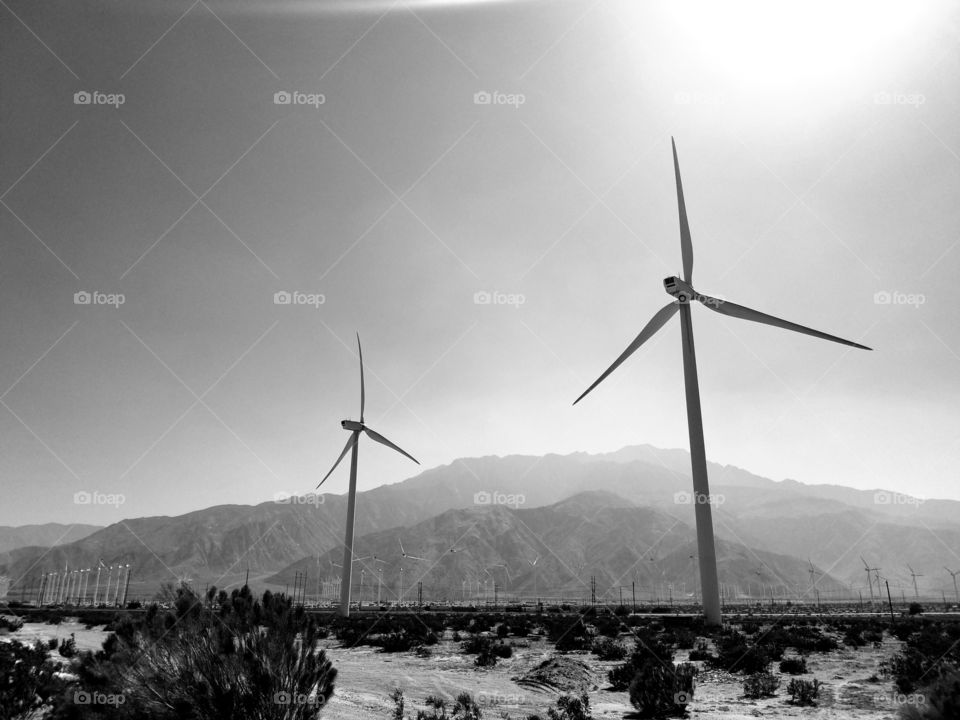 Wind power.
Wind turbines against desert hills. Black and white photo.