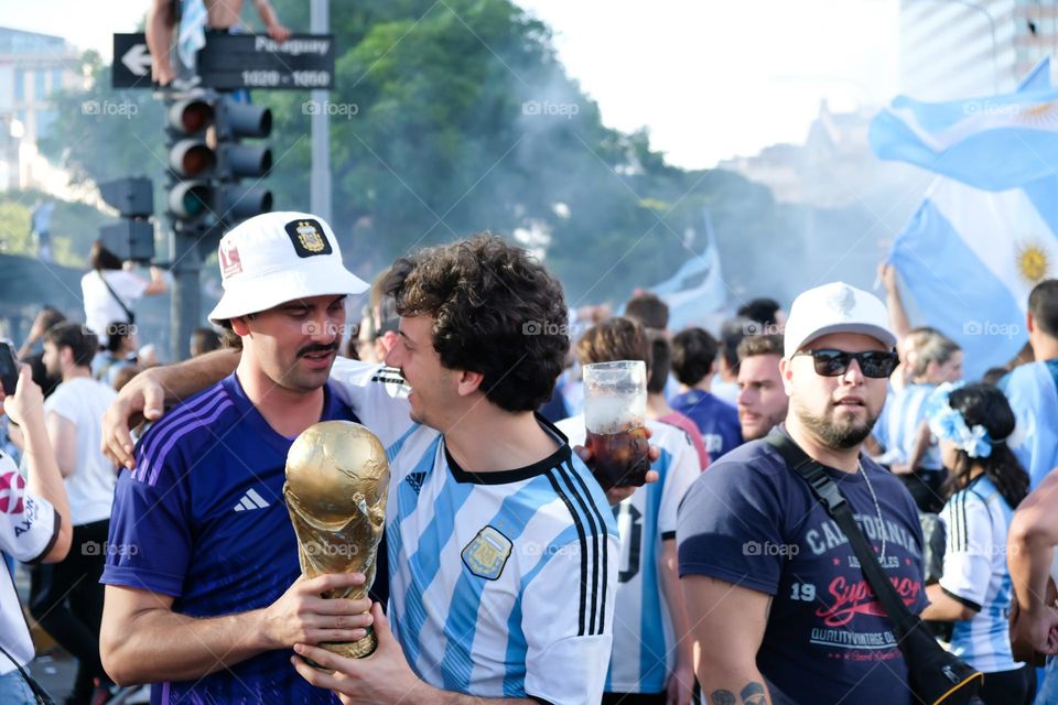 Buenos-Aires - 18.12.2022: Football fans of national team of Argentina in t-shirts on national team celebrating victory on the streets