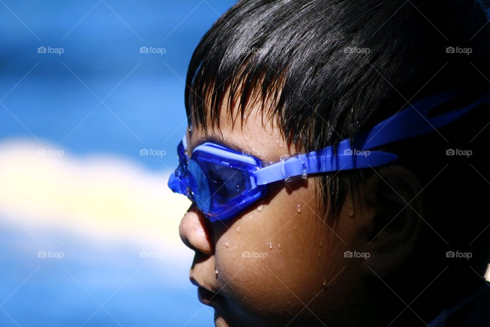 a young kid wearing swimming goggles