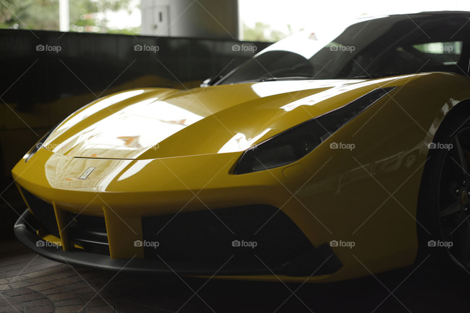 yellow Ferrari 488 spider coupe sports car 3.9 liter V8 twin turbo charged  (F154CB V8) close up front logo