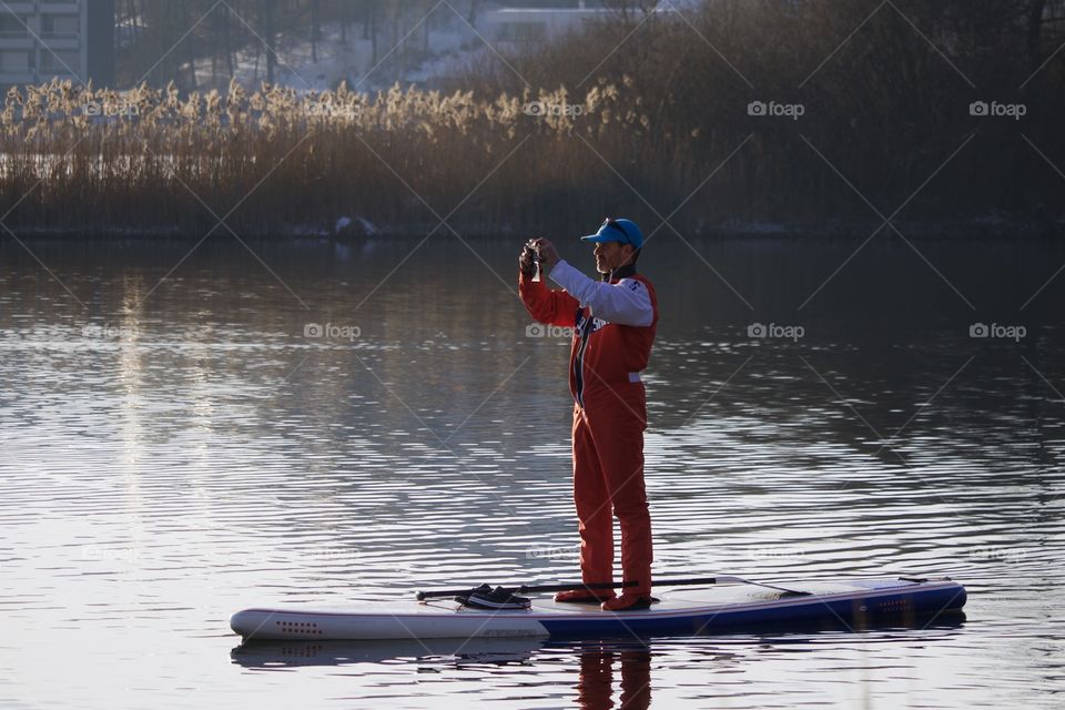 Stand Up Paddler With Cellphone