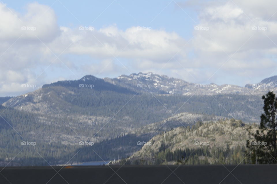 snow capped mountains with cloudy Blue Skies in the Sierra mountains